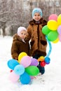 Beautiful girls with balloons in winter Royalty Free Stock Photo