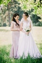 Funny girls Bride and bridesmaid with a bouquet