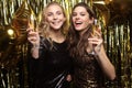 Beautiful girls celebrating New Year. Gorgeous smiling young women enjoying party celebration, having fun together