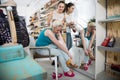 Two beautiful girls choose shoes in the store Royalty Free Stock Photo