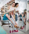 Two beautiful girls choose shoes in the store Royalty Free Stock Photo