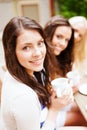 Beautiful girls drinking coffee in cafe