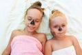 Beautiful girls with facial black clay mask