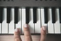 Beautiful girls fingers playing electronic piano keyboards. Royalty Free Stock Photo