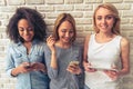 Beautiful girls with gadgets Royalty Free Stock Photo