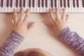 Beautiful girls hands playing electronic piano keyboards. Royalty Free Stock Photo