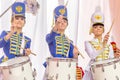 beautiful girls in a hussar uniform play drums at a carnival procession at a flower festival in a city park on a summer day