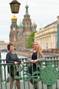 Beautiful girls are on Italian bridge across the Griboyedov Cana Royalty Free Stock Photo