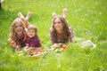 Beautiful girls with little boy on the grass Royalty Free Stock Photo