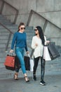 Beautiful girls with paper bags outside shopping mall Royalty Free Stock Photo