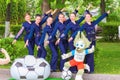 Beautiful girls in smart suits are photographed at the World Cup symbol of the Wolf waggons, preparing for a meeting of football f