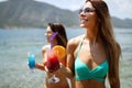 Beautiful fit girls in summer day having fun and cocktails on beach Royalty Free Stock Photo