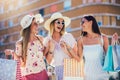 Beautiful girls in sunglasses with shopping bags in city Royalty Free Stock Photo