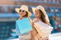 Beautiful girls in sunglasses with shopping bags in city Royalty Free Stock Photo