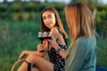 Beautiful girls tasting wine in a field near vineyard field. Celebrating successful harvest season. Couple having a romantic date Royalty Free Stock Photo