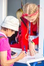 beautiful girls volunteers help an old football fan at the World Cup