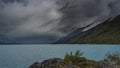 A beautiful glacial turquoise lake is surrounded by mountains. Royalty Free Stock Photo