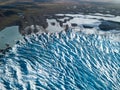 Beautiful glaciers flow through the mountains in Iceland. Aerial view and top view. Flowing Glacier in Greenland. Royalty Free Stock Photo