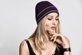 Beautiful glamorous blonde woman winter, spring or autumn portrait. girl wearing a warm hat and smart watch Royalty Free Stock Photo