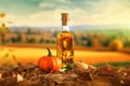 Beautiful glass bottle of pumpkin oil with orange and green pumpkins are standing on ground in field