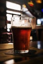 Beautiful glass of cold tasty dark beer in bar. Dark Background. Royalty Free Stock Photo