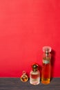 Beautiful glass jars with perfume on a red background Royalty Free Stock Photo