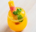 Beautiful glass of orange coctail decorated with colorful iced Royalty Free Stock Photo