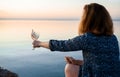 A beautiful glass with pink wine in the hands of a young girl. A glass of wine at sunrise. Romantic breakfast Royalty Free Stock Photo