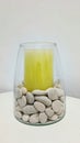 Beautiful glass tube filled with large aromatic candles and small stone arrangement. Royalty Free Stock Photo