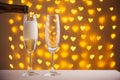 Beautiful glasses of champagne on a blurred background of hearts