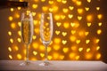 beautiful glasses of champagne on a blurred background of hearts