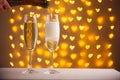 Beautiful glasses of champagne on a blurred background of hearts