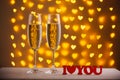 Beautiful glasses of champagne on a blurred background of hearts