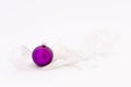 Beautiful purple christmas ball with white ribbon Royalty Free Stock Photo