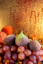 Beautiful glowing bokeh on a blurred background of water drops. Grapes and figs. Autumn composition of fruits. Copy