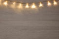 Beautiful glowing Christmas lights on white wooden table, top view. Space for text Royalty Free Stock Photo