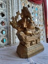 Beautiful gold color Lord Ganesha Statue with Marigold Garland at entrance of Marriage hall or Kalyana Matapa during hindu wedding