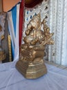 Beautiful gold color Lord Ganesha Statue with Marigold Garland at entrance of Marriage hall or Kalyana Matapa during hindu wedding