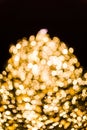 Beautiful gold-colored bokeh lights in the dark - perfect for a lit background