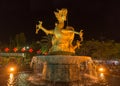 Beautiful, gold colored dragon sculpture stands over a fountain, Phuket Town, Thailand