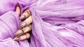 Beautiful gold manicure nails on pink tulle background . Manicure and nails concept. Trendy nails Royalty Free Stock Photo