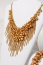 Beautiful gold necklace and bracelet on a mannequin Royalty Free Stock Photo
