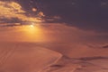 Beautiful gold sand dunes and dramatic sky with bright clouds