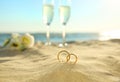 Beautiful gold wedding rings on sandy beach Royalty Free Stock Photo