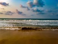 Beautiful golden beach of Puri with sea waves and blue cloudy sky in Odisha, India Royalty Free Stock Photo