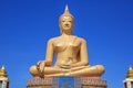 Beautiful of golden Big Buddha against blue sky background in Sing Buri, Thailand Royalty Free Stock Photo