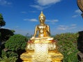 Beautiful Golden Buddha statue against blue sky and clouds in Thailand temple, Wat Phra That Phasornkaew Khao Kho District, Royalty Free Stock Photo