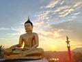Beautiful Golden Buddha statue against sunset sky in Thailand temple Royalty Free Stock Photo