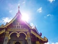 Beautiful golden chapel of temple with a backdrop of blue sky