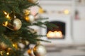 Beautiful golden Christmas ball hanging on fir tree branch against blurred background. Space for text Royalty Free Stock Photo